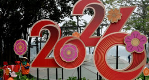 Workers tend to flowers next to a 2026 New Year banner in Hanoi on December 31 2025. Photo by Nha